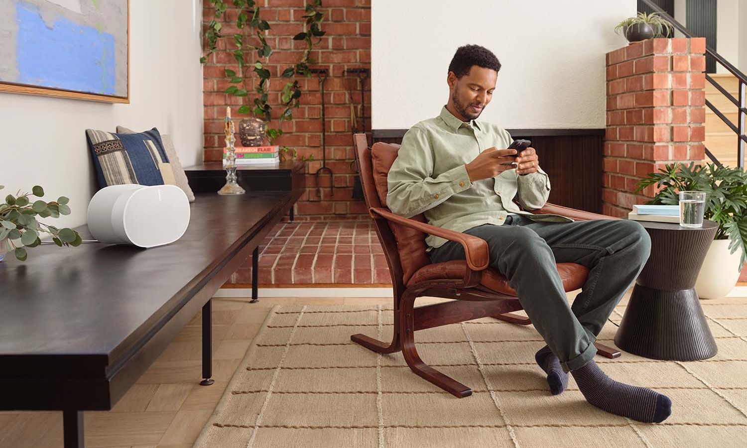 Woman Playing with AirPlay in her Sonos Roam in green