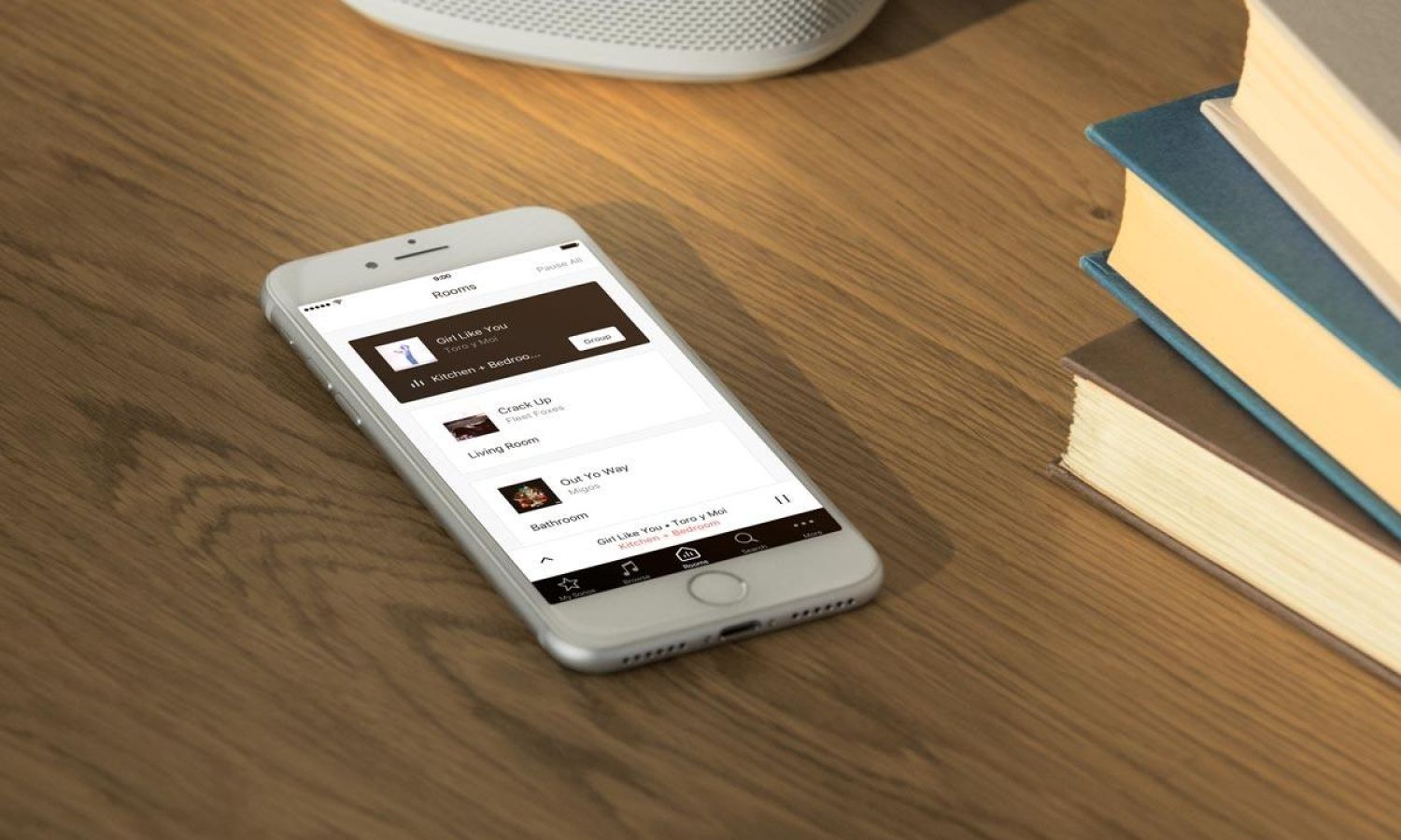 Sonos App in an iPhone on a wood table