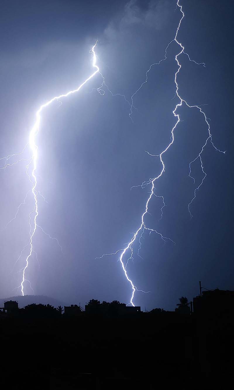 Lightning strike in a dramatic sky representing whole-home surge protection