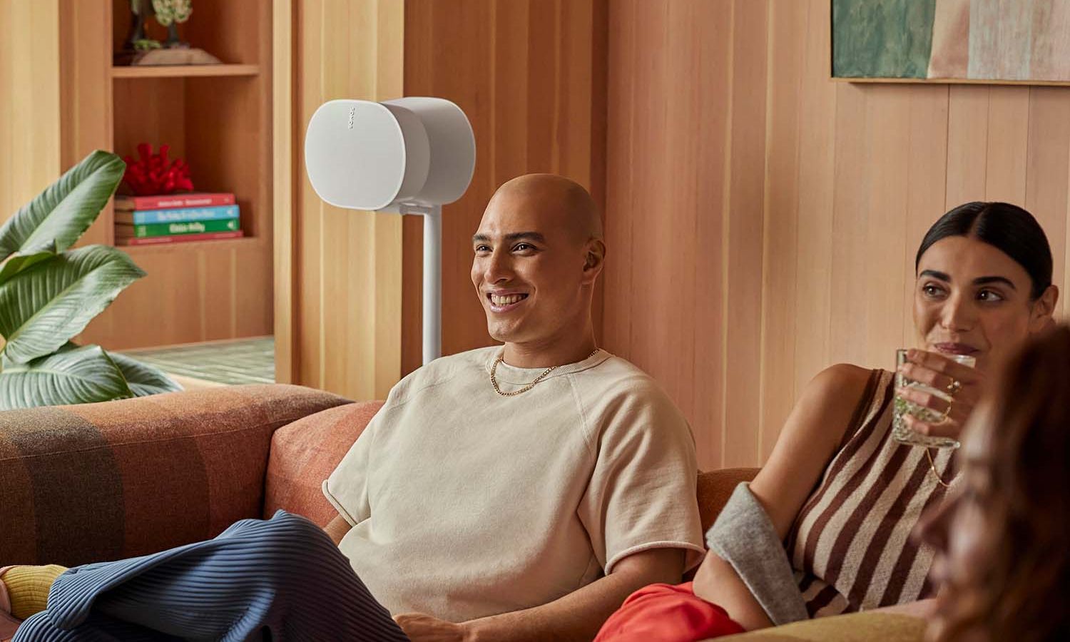 Person using voice commands with a Sonos smart speaker for hands-free control