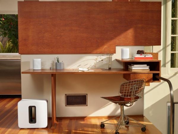 Home office with a Sonos speaker on a desk for focused listening while working