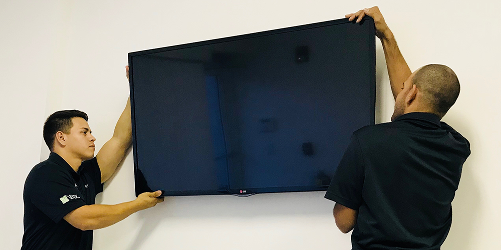 2 men mounting tv on wall